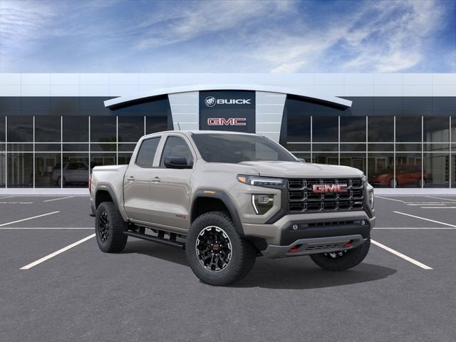 2026 GMC Canyon AT4 in Coastal Dune — front three-quarter view